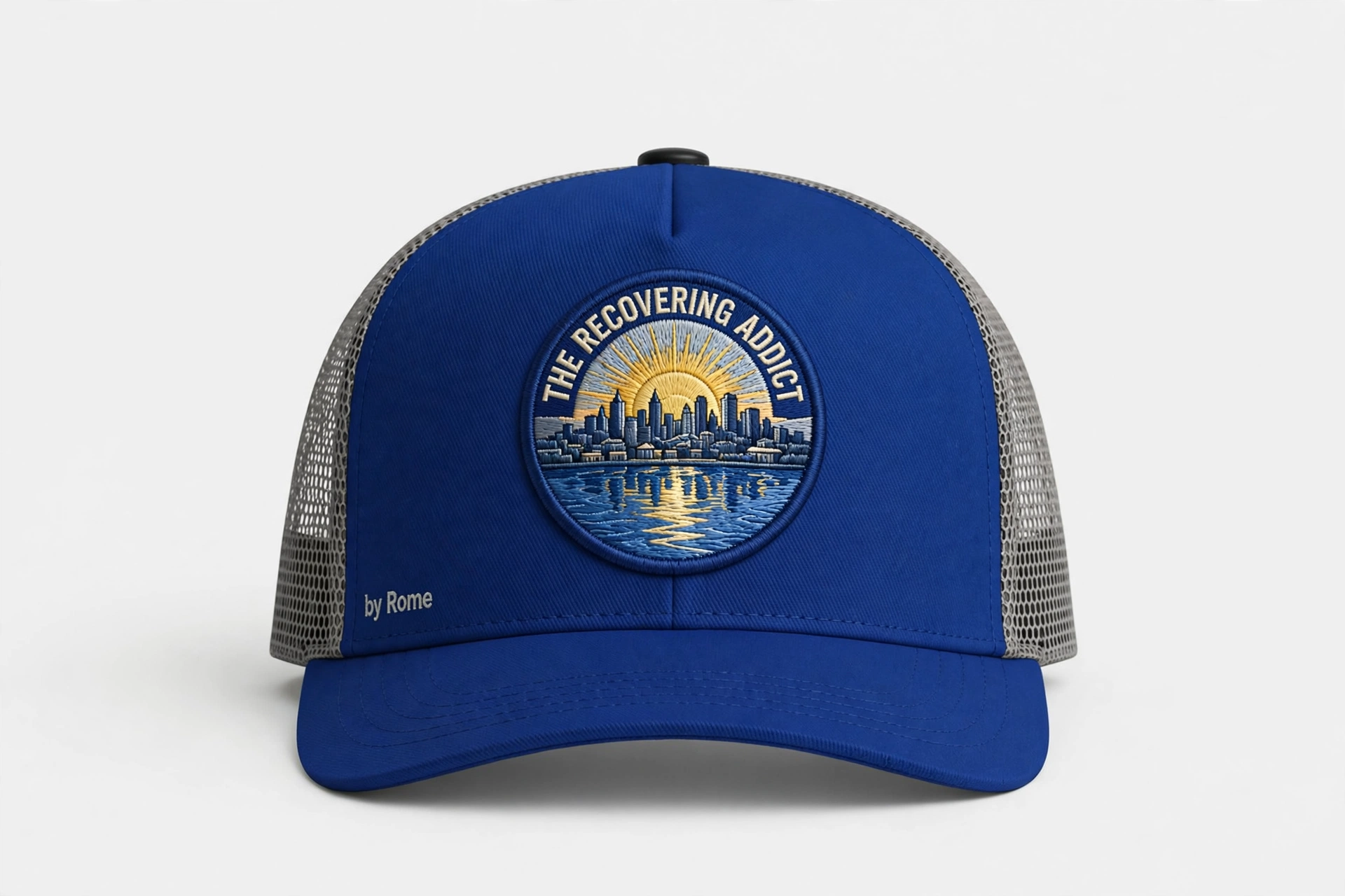 Heather Grey and Black trucker hat with a round The Recovering Addict Minneapolis sunrise, skyline, and river patch