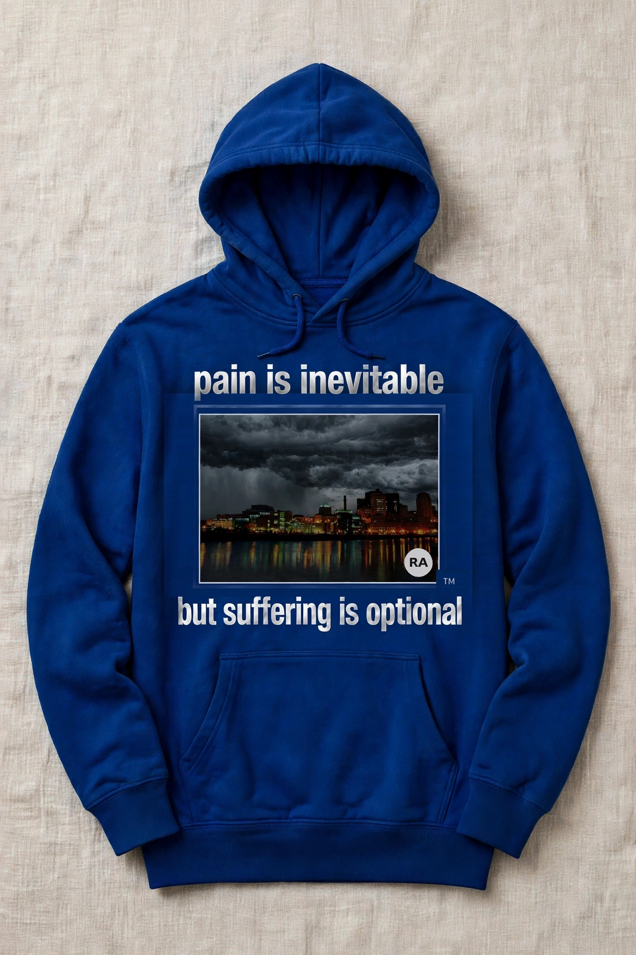 Royal-blue Pain Is Inevitable hoodie with a wide night view of the downtown Saint Paul riverfront and the words but suffering is optional