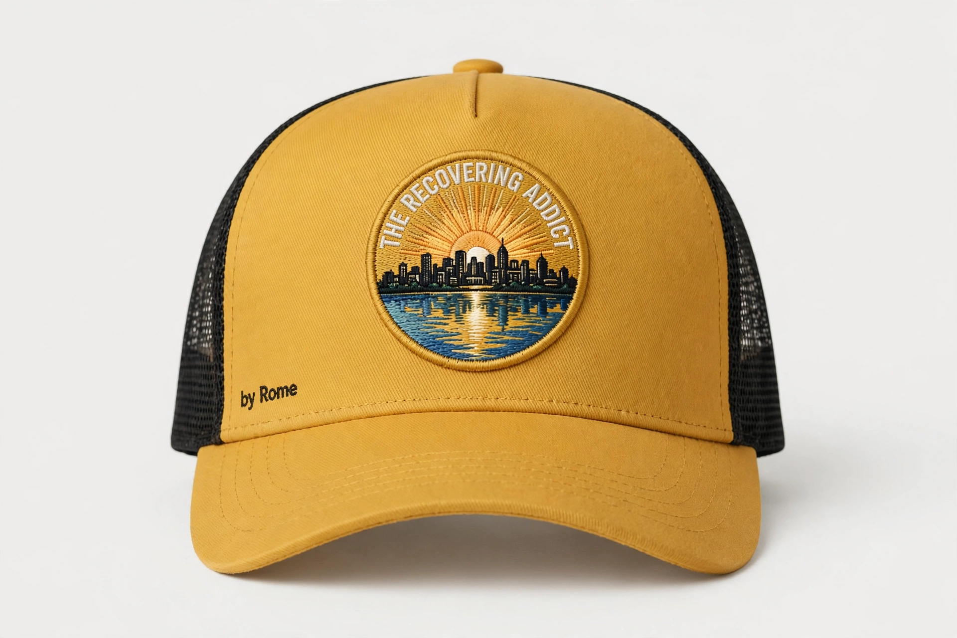 Charcoal and Black trucker hat with a round The Recovering Addict Minneapolis sunrise, skyline, and river patch